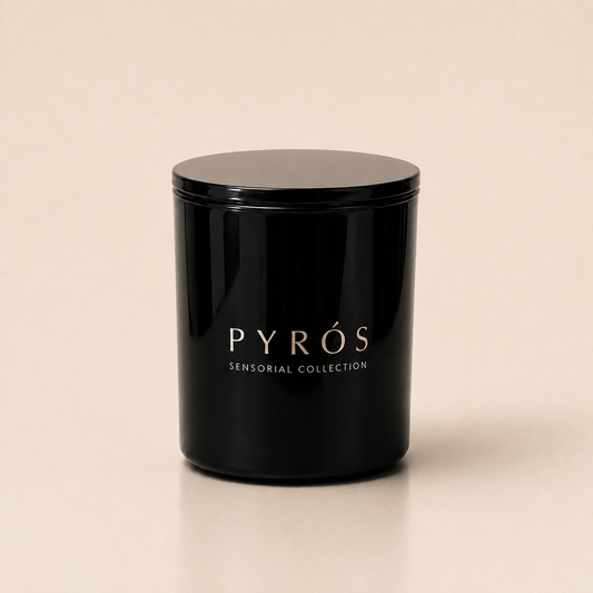 Flamma Hestia PYRÓS luxury candle in a reusable black glass vessel, smoky oud and leather fragrance