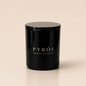 Flamma Hestia PYRÓS luxury candle in a reusable black glass vessel, smoky oud and leather fragrance
